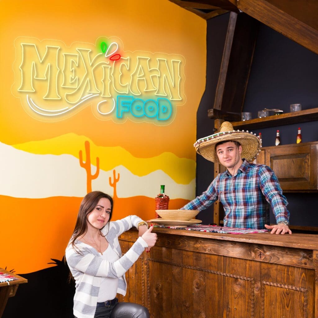 Dos personas, una de ellas con sombrero, están paradas en un mostrador de madera bajo un cartel de "Comida Mexicana" con un mural del desierto de fondo.