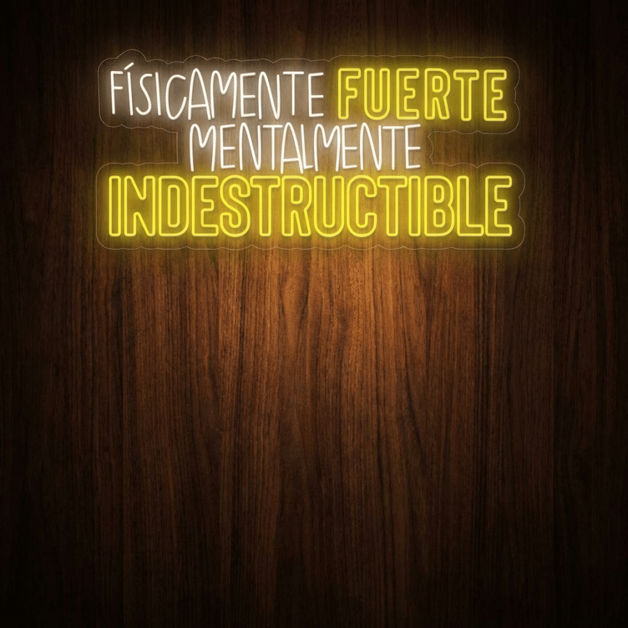 Cartel de neón blanco y amarillo sobre fondo de madera oscura en el que se lee: "Físicamente fuerte, mentalmente indestructible.