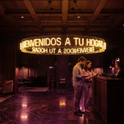 Lámpara de neón 360 grados con frase BIENVENIDOS A TU HOGAR colgando en lobby de hotel