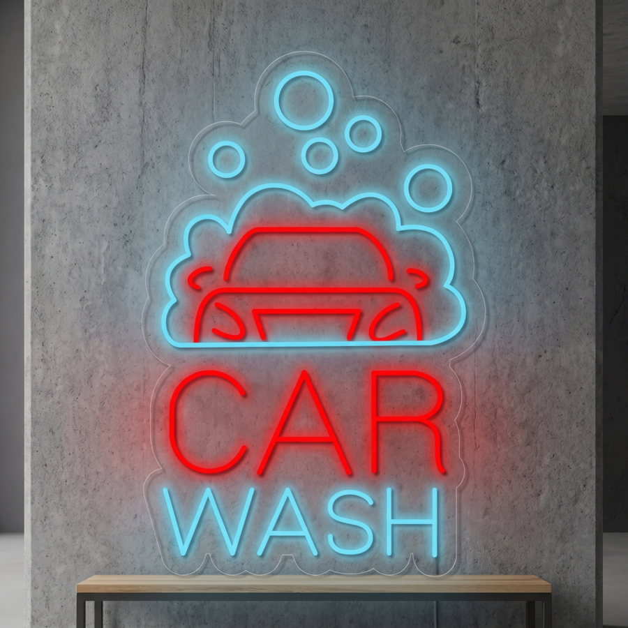Un letrero de neón en una pared gris muestra un coche rojo bajo unas burbujas de jabón azules, con las palabras «CAR WASH» en letras rojas y azules.