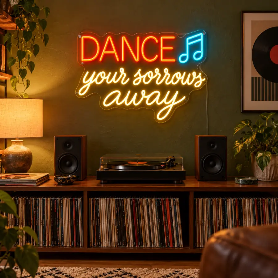 Montaje ambiental del cartel LED neón Dance your sorrows away en un rincón musical doméstico, sobre consola de vinilos con plato y altavoces